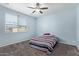 Bedroom with a ceiling fan and a window at 7620 W Pioneer St, Phoenix, AZ 85043