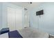 Cozy bedroom featuring neutral carpet, blue walls, a ceiling fan, and a convenient closet with sliding doors at 7620 W Pioneer St, Phoenix, AZ 85043