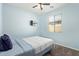 Comfortable bedroom with a ceiling fan and window offering natural light at 7620 W Pioneer St, Phoenix, AZ 85043