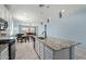 Modern kitchen featuring an island with granite countertops, white cabinets, and stainless steel appliances at 7620 W Pioneer St, Phoenix, AZ 85043