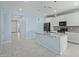 Modern kitchen featuring an island with granite countertops, white cabinets, and stainless steel appliances at 7620 W Pioneer St, Phoenix, AZ 85043