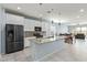 Modern kitchen with stainless steel appliances, granite countertops, and a large island at 7620 W Pioneer St, Phoenix, AZ 85043