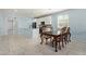 Bright open-concept living space featuring tile flooring, kitchen island, and dining area at 7620 W Pioneer St, Phoenix, AZ 85043