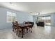 Open-concept kitchen, dining, and living space with ample natural light and tile flooring at 7620 W Pioneer St, Phoenix, AZ 85043