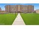 Multi-story apartment building with manicured lawn and inviting entrance at 7970 E Camelback Rd # 101, Scottsdale, AZ 85251
