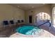 Inviting hot tub with seating under an archway, perfect for relaxation and enjoying the outdoors at 7970 E Camelback Rd # 101, Scottsdale, AZ 85251