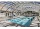 Bright indoor pool area features lounge chairs and a clear retractable roof for year-round enjoyment at 7970 E Camelback Rd # 101, Scottsdale, AZ 85251