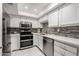 Updated kitchen features stainless steel appliances, white cabinets, and stylish backsplash and countertop at 7970 E Camelback Rd # 101, Scottsdale, AZ 85251