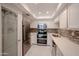 Modern kitchen featuring stainless steel appliances, sleek white cabinetry, and a tiled backsplash at 7970 E Camelback Rd # 101, Scottsdale, AZ 85251