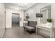 Lobby area features an elevator, a tufted bench, and decoratively framed mirrors on side tables at 7970 E Camelback Rd # 101, Scottsdale, AZ 85251