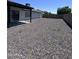 Spacious backyard with rock landscaping, covered patio, and privacy fence, perfect for outdoor enjoyment and relaxation at 8133 W Mclellan Rd, Glendale, AZ 85303