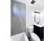 Bright bathroom with modern vanity, sleek black fixtures, and decorative lighting above the mirror at 8133 W Mclellan Rd, Glendale, AZ 85303