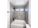 Modern bathroom featuring a tiled shower-tub with a built-in niche and sleek black fixtures at 8133 W Mclellan Rd, Glendale, AZ 85303
