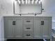 Bathroom double vanity featuring grey cabinets, a white countertop, black hardware, and ample drawer space at 8133 W Mclellan Rd, Glendale, AZ 85303