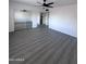 Bedroom with laminate flooring, ceiling fan, and mirrored closet doors at 8133 W Mclellan Rd, Glendale, AZ 85303