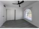 Bright bedroom with ceiling fan, laminate flooring and a window with a view at 8133 W Mclellan Rd, Glendale, AZ 85303