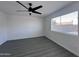 Bright bedroom with ceiling fan, laminate flooring and window with blinds at 8133 W Mclellan Rd, Glendale, AZ 85303