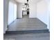 Bright dining area featuring modern gray floors, white walls, and stylish light fixture at 8133 W Mclellan Rd, Glendale, AZ 85303