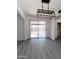 Bright dining area featuring modern gray floors and stylish light fixture with slider door at 8133 W Mclellan Rd, Glendale, AZ 85303