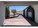 Exterior home view showing arched entry and desert landscaping at 8133 W Mclellan Rd, Glendale, AZ 85303