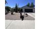 Landscaped front yard with desert plants, gravel, and decorative wagon wheel, showcasing southwest curb appeal at 8133 W Mclellan Rd, Glendale, AZ 85303