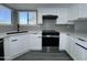 Kitchen with gray backsplash, stainless steel oven, and light countertops at 8133 W Mclellan Rd, Glendale, AZ 85303