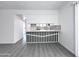Modern kitchen pass-through with stylish black and white accents and gray wood flooring at 8133 W Mclellan Rd, Glendale, AZ 85303
