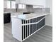 Modern kitchen pass-through with white cabinetry, subway tile, and white countertops at 8133 W Mclellan Rd, Glendale, AZ 85303