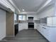 Bright kitchen boasts new white cabinets, stainless appliances, and ample counter space at 8133 W Mclellan Rd, Glendale, AZ 85303