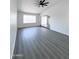 Bright, open living area with gray wood floors, white walls and natural light at 8133 W Mclellan Rd, Glendale, AZ 85303