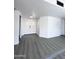 Bright living room with gray wood floors and white walls creates a modern, airy feel at 8133 W Mclellan Rd, Glendale, AZ 85303