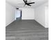 Spacious living room with a modern ceiling fan and neutral paint throughout the space at 8133 W Mclellan Rd, Glendale, AZ 85303