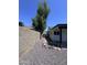 Sideyard featuring rock landscaping and a pathway, offering a practical and visually appealing outdoor space at 8133 W Mclellan Rd, Glendale, AZ 85303