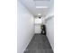 Narrow utility room has an energy-efficient water heater, storage, and neutral tile flooring at 8133 W Mclellan Rd, Glendale, AZ 85303