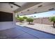 The backyard features neutral rock landscaping, mature trees, and covered patio at 8230 E Navarro Ave, Mesa, AZ 85209