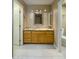 Bathroom featuring a wood vanity, granite countertop, updated mirror and hardware at 8230 E Navarro Ave, Mesa, AZ 85209