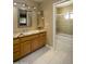 Bathroom featuring granite countertop, wood vanity, updated mirror and hardware, and updated walk-in shower at 8230 E Navarro Ave, Mesa, AZ 85209