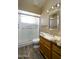 Bathroom with updated marble counters, wood floors, and walk-in shower at 8230 E Navarro Ave, Mesa, AZ 85209