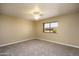 Bright bedroom with carpet flooring, ceiling fan, and large window overlooking the neighborhood at 8230 E Navarro Ave, Mesa, AZ 85209