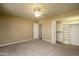 Neutral bedroom featuring carpet floors, ceiling fan, and closet with organized shelving at 8230 E Navarro Ave, Mesa, AZ 85209