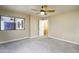 Neutral bedroom featuring carpet flooring, closet, ceiling fan, and light beige walls at 8230 E Navarro Ave, Mesa, AZ 85209