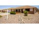 Single story home with desert landscaping in front, charming entrance, and terracotta colored roof tiles at 8230 E Navarro Ave, Mesa, AZ 85209
