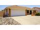 Single story home featuring a two car garage, desert landscaping, and a charming entrance with brick accents at 8230 E Navarro Ave, Mesa, AZ 85209
