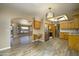 Open kitchen with wooden cabinets, stainless steel appliances, and plenty of counter space with a light toned backsplash at 8230 E Navarro Ave, Mesa, AZ 85209