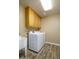 Laundry room featuring full size washer and dryer, cabinets and tiled floors at 8230 E Navarro Ave, Mesa, AZ 85209