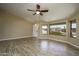 Inviting living room with wood-style flooring, a ceiling fan, and ample natural light from large windows at 8230 E Navarro Ave, Mesa, AZ 85209
