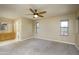 Spacious main bedroom offers carpet flooring, windows, vanity and sink, with an open bathroom at 8230 E Navarro Ave, Mesa, AZ 85209