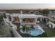 Aerial view of luxurious home featuring a pool, spa, patio, and stunning desert landscape at 9441 N 129Th Pl, Scottsdale, AZ 85259