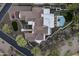Stunning aerial view of the estate showcasing its roofline, pool, putting green and landscaping at 9441 N 129Th Pl, Scottsdale, AZ 85259