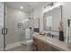 Modern bathroom with glass shower, neutral tile, black hardware and granite counters at 9441 N 129Th Pl, Scottsdale, AZ 85259